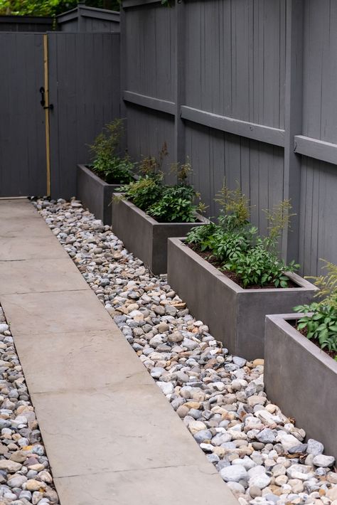 River Rock Raised Garden Bed, Rock Garden Bed With Pots, River Rock Garden Bed, Rock Garden Planter Ideas, Rock Garden With Pavers, Front Rock Landscaping Ideas, Garden Ideas Stones, Planters In Rock Beds, Raised Rock Flower Beds