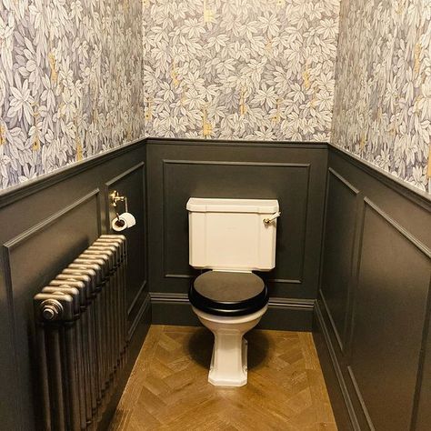 A small downstairs loo with black panelling and striking wallpaper. From the home of @homes_and_adventures_ on instagram. Panelled Downstairs Loo, Downstairs Toilet Ideas Under Stairs, Small Panelled Bathroom, Panelled Downstairs Toilet, Black Downstairs Toilet, Cloakroom Panelling, Downstairs Toilet Panelling, Utility Toilet, Dark Walnut Floors