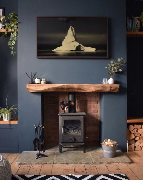 With a modern sensibility, some smart editing, and a hint of rustic blue, you can create a space that feels alive with color and rich in history at the same time. Here's how. #hunkerhome #blue #blueinterior #bluepaint #bluewalls Blue Living Room Ideas, Log Burner Living Room, Dark Blue Living Room, Navy Living Rooms, Snug Room, Feature Wall Living Room, Dark Living Rooms, Living Room Decor Fireplace, Cottage Living Rooms