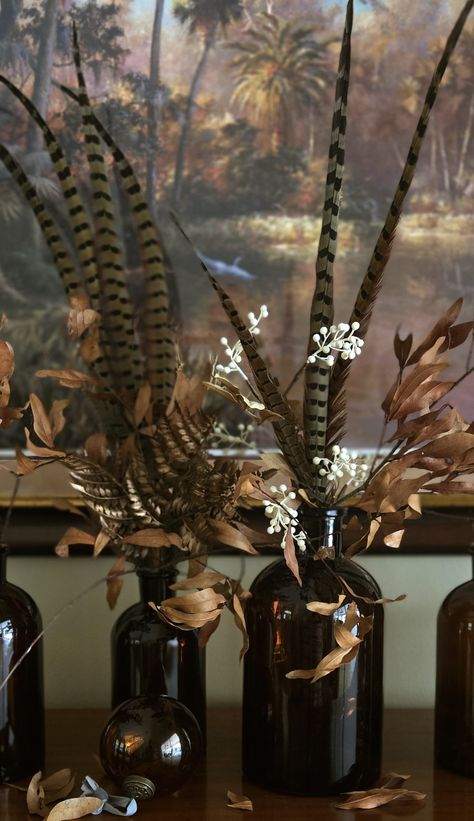 Amber glass and pheasant feathers Fall Pheasant Decor, Turkey Feather Arrangement, Floral Arrangement With Pheasant Feathers, Pheasant Feather Decor Wedding, Pheasant Feather Christmas Tree, Turkey Feather Centerpiece, Duck Wedding Decor, Amber Glass Christmas Decor, Pheasant Wedding Decor