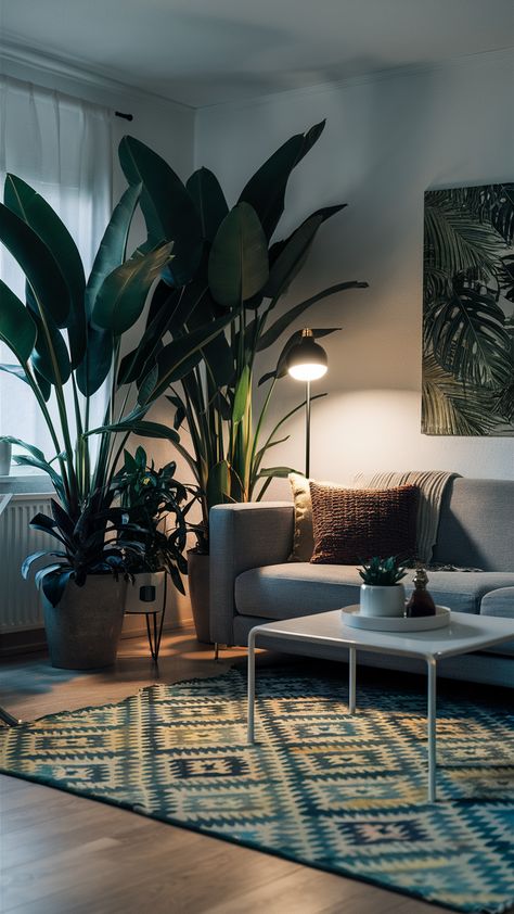 Bring the lush beauty of the tropics into your living space with this stunning IKEA-inspired design! Large tropical plants paired with a sleek modern sofa create a vibrant focal point, while a minimalist white coffee table and geometric rug enhance the inviting atmosphere. Don't forget the statement wall art that adds personality to your decor! With soft ambient lighting from a stylish floor lamp, this living room is perfect for relaxation and entertaining. Ready to transform your home? Discover more ideas and tips for incorporating tropical plants into your decor! #TropicalLiving #IKEAStyle #HomeDecorIdeas #IndoorPlants #ModernDesign #LivingRoomInspo #PlantStyling Ikea Style, Statement Wall Art, White Coffee Table, Stylish Floor Lamp, Tropical Living, Tropical Oasis, Minimalist White, Statement Wall, Coffee Table White