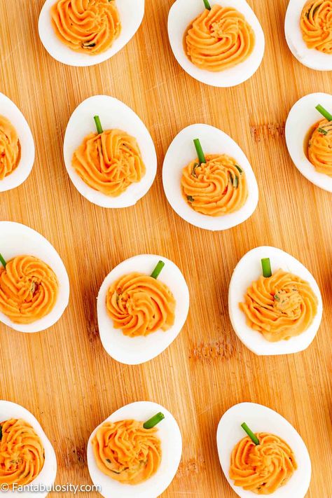 These deviled eggs are made to look like pumpkins and are so fun for Thanksgiving and Halloween! #pumpkin #deviled #eggs #halloween #thanksgiving Smokey Pumpkin Deviled Eggs, Fall Themed Deviled Eggs, Deviled Egg Pumpkins, Devil Deviled Eggs, Devilled Eggs Halloween, Deviled Eggs Decoration Ideas, Deviled Eggs Recipe Best Halloween, Pumpkin Deviled Eggs Recipe, Deviled Eggs Pumpkin