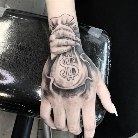 Money Bag Tattoo On Hand Money Bag Tattoo Behind Ear, Money Bag Tattoo On Hand, Hand Tattoo Men, Money Sign Tattoo, Dollar Sign Tattoo, Money Bag Tattoo, Dollar Tattoo, Bag Tattoo, Rib Tattoos For Guys