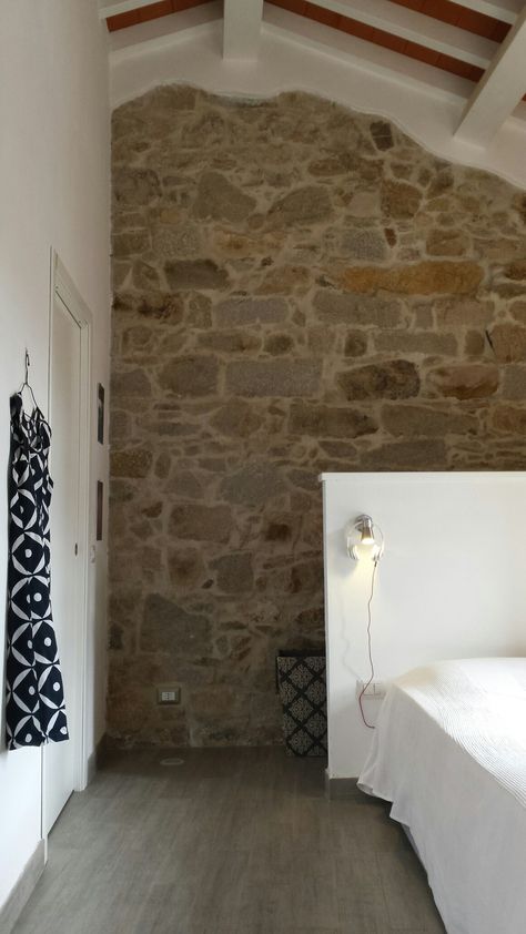 Roberta Zanetti architecture La Maddalena Island  Hidden cabinet  behind the bed robertazanettiroma@gmail.com Farmhouse Roof, Stone Bedroom, Hidden Cabinet, Stone Wall Design, Barn Living, Stone Walls, Mountain House, Stone House, Accent Walls