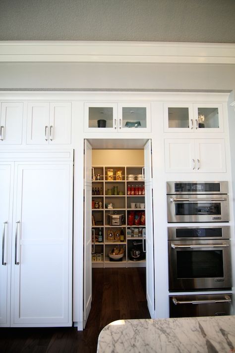 Fantastic kitchen features concealed pantry hidden behind pantry cabinet doors flanked by bi-fold cabinet doors to the left and microwave oven stacked over oven and warming drawer to the right. Concealed Pantry, Small Kitchen Pantry, Kitchen Pantry Doors, Hidden Pantry, Pantry Drawers, Cabinet Closet, Hidden Kitchen, Pantry Closet, Diy Pantry