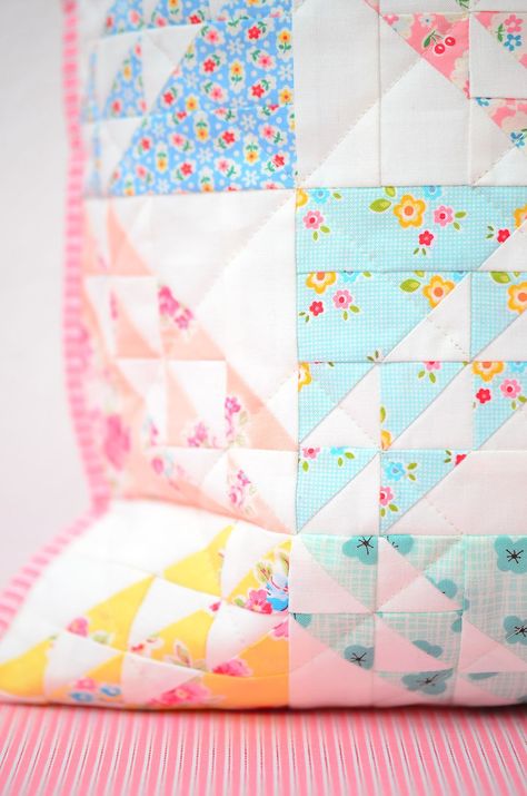 The Spring Meadow Spring quilt patterns combine reproduction prints with cute little florals, basic pastels, a simple piecing technique and a sense of nostalgia... This quilty project comes in two sizes - a 16" pillow or mini quilt and a lap quilt measuring 64" x 72". Check out my blog at ellisandhiggs.com for some fun pattern add-ons! Nadra Ridgeway, ellis & higgs. Spring quilt, Spring quilt pattern, Spring quilt projects, Quilted Pillow, Quilt Pattern, Half Square Triangles, HSTs. Spring Quilt Patterns, Pastel Quilts, Pillow Quilt, Mini Quilt Patterns, Basic Quilt, Spring Quilts, Spring Meadow, Painted Rocks Kids, Scrap Quilt Patterns