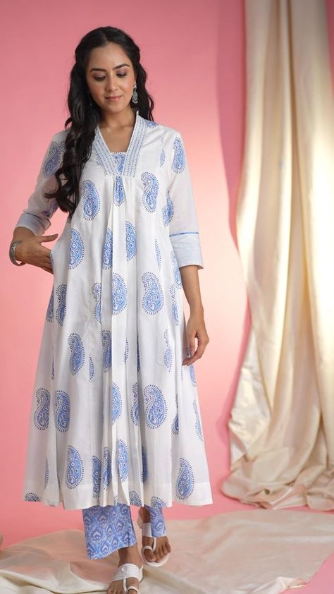 AVDAF281 Elevate your ethnic wardrobe with our exquisite Cotton Kurta Palazzo Set. Crafted from soft white fabric adorned with delicate booti patterns, the kurta features intricate handblock prints, a flattering A-line silhouette, and a V-neck highlighted with katha and bead work. The 3/4th sleeves with thread detailing and piping add an elegant touch, while the convenient pocket on one side offers functionality. Paired with light blue palazzos, boasting a comfortable back elastic.