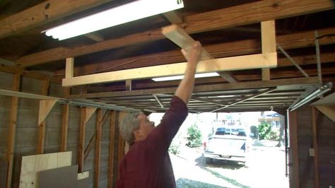 Garage Door Rack | Today's Homeowner Unfinished Ceiling, Pole Barn Shop, Timber Storage, Garage Racking, Wood Garage, Barn Shop, Slanted Ceiling, Door Rack, Ceiling Storage