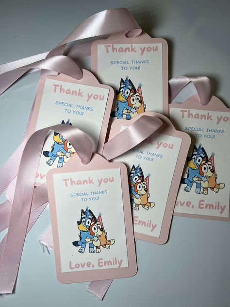 NO RETURNS, NO REFUNDS, NO EXCHANGE Please read descriptions carefully. By purchasing you have read and agreed to our terms and conditions. Add a touch of Bluey magic to your next celebration with our adorable Bluey Themed Favor Tags! 🎉  These favor tags are not only a wonderful addition to your party decor but also make great keepsakes for your guests to cherish. They can be attached to party favors, gift bags, cupcakes, or even used as table decorations. Your guests will love them, and your little Bluey fan will be over the moon! Product Details: - Made from high-quality cardstock - Vibrant, full-color printing - Pre-cut holes for easy attachment with ribbon - 11" light pink ribbon Bluey Thank You Tags, Bingo Party, 2nd Birthday Party For Boys, Dog Themed Parties, Bluey Party, Bluey And Bingo, Bluey Birthday, Peppa Pig Birthday, Blue Dog