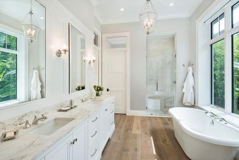 Nothing beats a classic small freestanding bathtub. Wooden floors help to provide a more rustic feel to any home. In a contrast, a small freestanding bathtub, such as the one pictured here, helps to provide a touch of modernity. This is proof that you donât need a large bathtub to provide a large statement in your bathroom. Beach Style Bathroom, Wood Floor Bathroom, Bathroom Wood, Best Kitchen Design, White Wood Floors, Wood Floors Wide Plank, Transitional Bathroom, Bathroom Photos, Trendy Bathroom