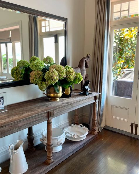 The sturdy, gracefully carved legs and refined detailing add a touch of sophistication, while the natural wood’s character ensures it remains a striking focal point in any room. Whether placed against a wall or as a centerpiece in a hallway, this console table marries functionality with beauty, making it an ideal stage for showcasing hydrangeas. Restoration Hardware Timber Console - $899 #secondhand #furniture #marketplace #smallbusiness #restorationhardware #interiordesign Hall Entrance, Carved Legs, Restoration Hardware, Console Table, Hydrangea, Focal Point, Natural Wood, Hallway, Entrance