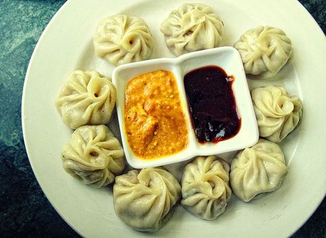 A typical serving of momo with sesame yellow sauce and red ginger chilli sauce in Nepal