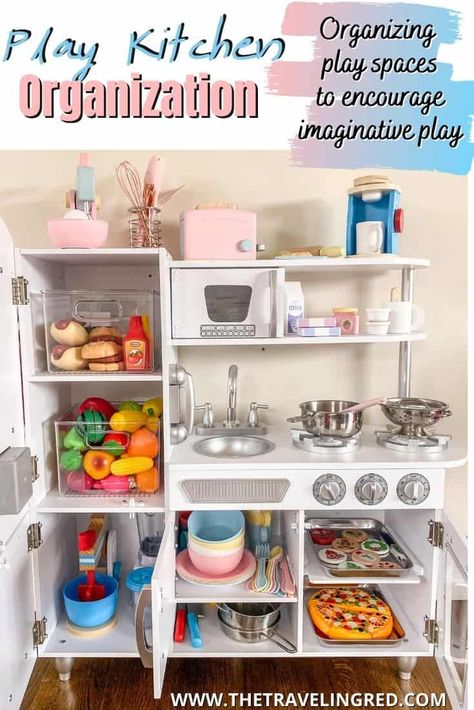 PLAY KITCHEN ORGANIZATION TO ENCOURAGE IMAGINATIVE & PRETEND PLAY by The Traveling Red Play Kitchen Small Space, Play Kitchen In Kitchen, Play Kitchen Must Haves, Toy Food Organization, Playroom Kitchen Organization, Diy Pretend Kitchen, Pretend Play Organization, Toy Kitchen Storage Ideas, Pretend Play Kitchen Diy