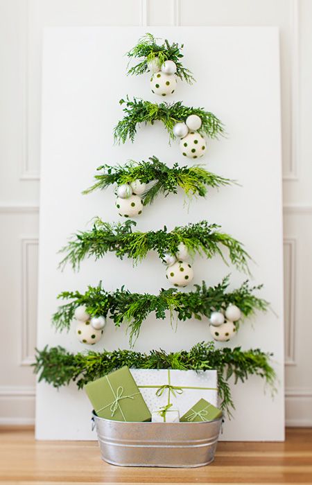 Get the scent and feel of a real tree in a fraction of the space by fastening greenery to a panel. --Lowe’s Creative Ideas Planet Ideas, Wall Christmas Tree, Alternative Christmas, Alternative Christmas Tree, Tree Ideas, Noel Christmas, Diy Christmas Tree, Christmas Deco, Xmas Crafts