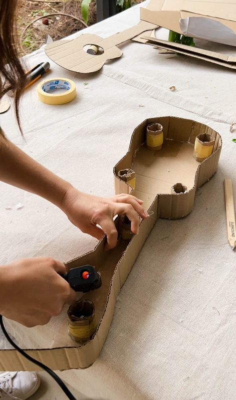 A Pair & A Spare | Making a Kids Cardboard Guitar How To Make Guitar With Cardboard, How To Make A Guitar Out Of Cardboard, Cardboard Guitar Diy, Kids Guitar Craft, Cardboard Guitar, Cardboard Camera, Diy Crafts For Boyfriend, Guitar Crafts, Diy Resin Table