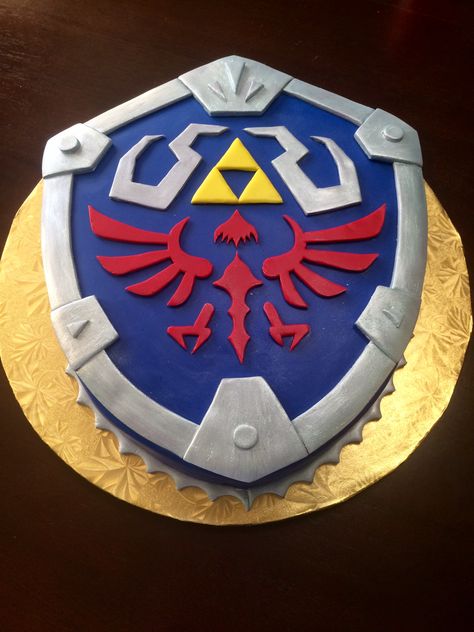 Hylian Shield groom's cake from Legends of Zelda made out of chocolate cake! #GroomsCake #Wedding #ChocolateCake #Zelda #HylianSheild #TheHungryHood Legends Of Zelda, Zelda Cake, Zelda Party, Zelda Wedding, Hylian Shield, Recipes Using Bananas, Dragon Cakes, Zelda Birthday, Cake Wrecks