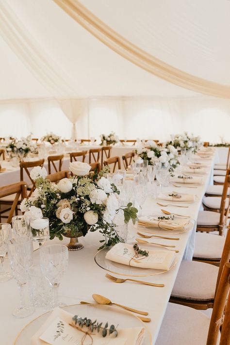 Banquet tables complete with white tablecloths, white floral arrangements and gold cutlery finished with fabric napkins tied with brown string Wedding Table Champagne Color, Beige Wedding Theme Table Settings, Wedding White And Beige, Brown Table Wedding Decor, Wedding Banquet Table Decorations, Wedding Table Dressing, Wedding Table White Tablecloth, Engagement Table Set Up, White Linen Wedding Table