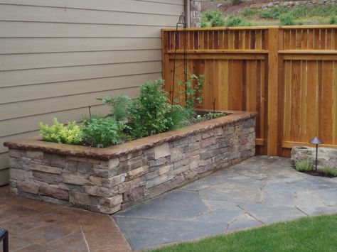 Raise vegetable bed with cultured stone side walls and fitted iron mt stone pathway. Stone Planter Boxes, Tall Planter Boxes, Stone Flower Beds, Brick Planter, Diy Patio Pavers, Stone Planter, Vegetable Beds Raised, Raised Planter Boxes, Patio Pavers