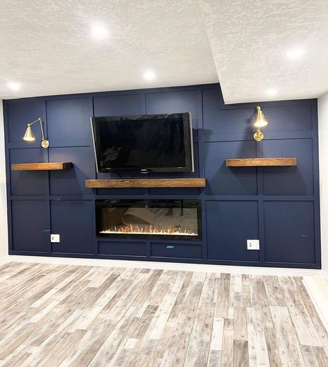 Basements don't have to be boring - introducing our board and batten accent walls. Sure to transform a drab wall to a fab wall! Reach out for a custom quote. 

Keywords: Accent Wall, Accent Walls, Feature Wall, Feature Walls, Accent Wall Idea, Feature Wall Idea, Board and Batten Wall, Board and Batten Accent Wall, Board and Batten, Living Room Design, Living Room Inspiration, Living Room Ideas, Accent Wall Inspiration, Statement Piece, Statement Wall, Wall Transformation. Navy Blue Board And Batten Wall Living Room, Dark Blue Accent Wall Living Room With Fireplace, Shelves On Board And Batten Wall, Board And Batten Wall With Tv Mounted, Accent Wall In Garage, Board And Batten Electric Fireplace Wall, Wood Plank Accent Wall Living Room, Navy Living Room Accent Wall, Man Cave Accent Wall Ideas