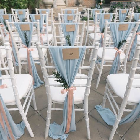 Impart a truly sophisticated allure to your wedding by arranging a charming wedding chair decor and make your guests feel festive. Create one-of-a-kind chair decor by styling the white Chiavari chairs with light blue chiffon sashes and make them look elegant by tying them with blush ribbons and green leaf branches. Make your wedding chairs feel comfy by placing white chair pads and let your guests enjoy the wedding ceremony will pleasure. Wedding Chair Decor, Event Decor Ideas, Party Decorations Table, Charming Wedding, Wedding Chair Decorations, Wedding Chair, Chiavari Chairs, Ceremony Wedding, White Chair