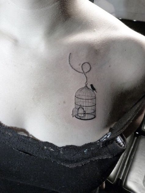 Girl with a tattoo on her upper chest of a birdcage with the  door open & bird outside Bird And Cage Tattoo Freedom, Tattoos Torso, Vegan Tattoos, Tattoos Mom, Birdcage Tattoo, Cage Tattoo, Candy Tattoo, Collarbone Tattoo, Freedom Tattoos