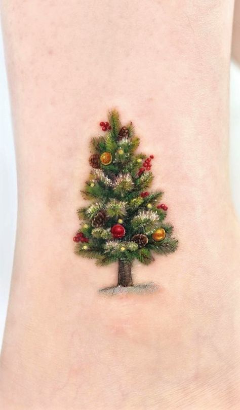 January Baby Tattoo Ideas, Christmas Tree Tattoos, Tiny Christmas Tattoo, Fine Line Christmas Tree Tattoo, Christmas Tree Tattoo Ideas, Small Christmas Tattoos For Women, Christmas Inspired Tattoos, Dainty Christmas Tattoos, Christmas Themed Tattoos