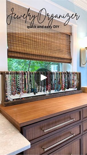 DIY Jewelry Organizer—I have more necklaces than a reasonable person needs, and yet still fewer than I want. 😃 So I needed a very simple way to store and organize them so they’d be easily accessible. This 46-inch DIY jewelry organizer was so quick and easy to make, and it kind of turns my necklaces into a colorful little art display in our bathroom. | Addicted 2 Decorating | Lunatic Souls · Big Cafe Necklace Storage Diy, Diy Necklace Display Craft Show, How To Organize Necklaces, Necklace Display Ideas, Diy Jewelry Organizer, Diy Necklace Display Stand, Diy Necklace Stand, Diy Bracelet Holder, Necklace Organizer Diy