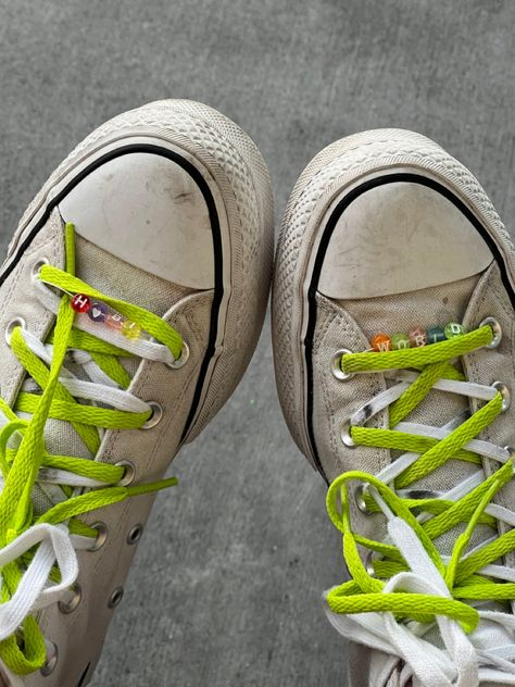 Close up of white converse with colorful lettered beads that spell out “hobi world” weaved through the shoelaces. There is also a bright green shoelace on each show to add a pop of color. Letter Beads On Shoelaces, Converse With Colored Laces, Beaded Shoelaces Converse, Beads Shoelaces, Converse Beads, Beads On Shoelaces, Beaded Shoelaces, Converse Shoelaces, Cool Shoelaces