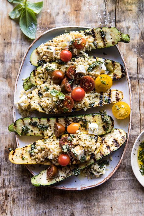 Grilled stuffed zucchini. A healthy vegetarian recipe of tomato, feta, and orzo stuffed inside a grilled pesto zucchini. This quick and easy dish is perfect for spring and summer days and doubles as a healthy dinner or simple side dish. Either way you serve it up, it's going to be a favorite. Zucchini Stuffed, Pesto Zucchini, Grilled Zucchini, Easy Pasta Salad, Half Baked Harvest, Summer Dinner, Zucchini Recipes, Vegetarian Recipes Healthy, Healthy Vegetarian