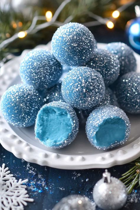 Blue Christmas Truffles start with a smooth white chocolate ganache, beautifully tinted by blue curacao, which adds a touch of warmth as they melt in your mouth. These truffles deliver a luscious blend of creamy white chocolate with a subtle citrusy note. White Chocolate Chips: 2 cupsHeavy Cream: 2 tablespoonsBlue Curacao: 2 tablespoonsSanding Sugar: 1/2 Irish Cream Truffles, Wine Truffles, Blue Curacao Liqueur, Christmas Truffles, White Chocolate Ganache, Blue Food Coloring, Blue Cakes, Truffle Recipe, Cake Truffles