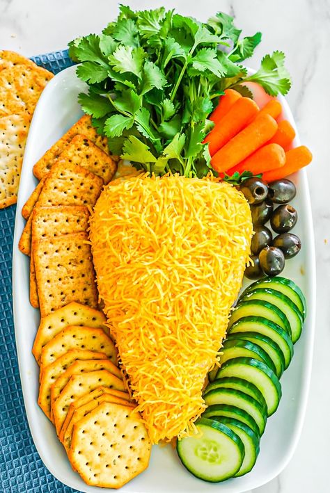 This playful Easter cheese ball is made with just 6 ingredients including cream cheese, cheddar, bacon, ranch seasoning mix, and Worcestershire sauce. Formed into the shape of a carrot, sprinkled with cheese, and finished off with fresh leafy greens for the carrot top, this adorable appetizer is colorful, fun, and delicious with crackers! Easter Cheese Ball Recipes, Carrot Cheese Ball, Easter Cheese Ball, Easter Cheese, Easter Party Food, Cheese Ball Recipe, Easter Appetizers, Shredded Cheddar Cheese, Apple Dessert