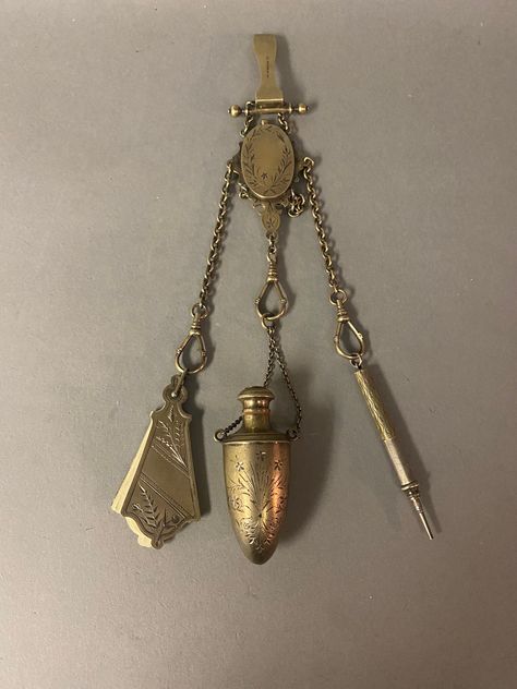 "A lovely Victorian sterling silver chatelaine with etched aesthetic floral, vine & leaf, circa 1880 with all the necessities needed for the Victorian lady. Includes three pendants also with matching etching: a note book with unused paper , a pencil, and a scent bottle with threaded top. In very good condition, marked 926 sterling 38 on the clip. Weight 3.95 ozt.  Measures: 11.25\" Length  Perfume 2.75\" x 1.5\" Pencil 3.25\" x .25\" Note pad 3\" x 1.25\" See photos. Chatelaines became the rage for women of every economic background in the 19th Century. They could be easily customized to your needs, whether you were a society hostess, nurse or secretary. Often fully intact and original chatelaines can tell the story of its owner and as well as her station in life." Chainmaille Jewelry Patterns, 90s Harajuku, Victorian Accessories, Aesthetic Floral, Victorian Lady, Scent Bottle, Note Book, Chatelaine, Floral Vine