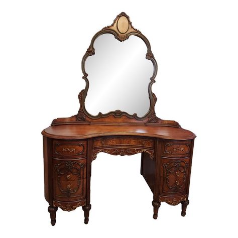 This desk is in excellent condition. It has beautiful accent moldings, gorgeous hardware on the 7 dovetailed drawers. The mirror has a unique curved base. This piece is stunning! Measurements: 52" wide, 21" deep, 30" tall without mirror, 71" tall to mirror Top drawers: 9" wide, 15" deep, 4" tall Middle drawers: 9" wide, 15" deep, 5" tall Bottom drawers: 9" wide, 15" deep, 5" tall Center drawer: 19.5" wide, 10.5" deep, 2.5" tall Unique Vintage Furniture, Vintage Gold Room, Antique Vanity Ideas, Vintage Standing Mirror, Vintage Vanity Aesthetic, Antique House Decor, Vintage Vanity Table, Intricate Woodwork, Victorian Style Furniture