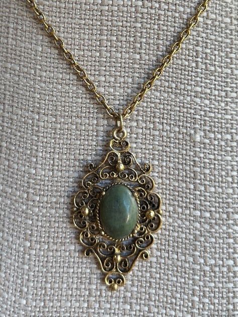 Vintage Victorian Revival Bronze Nephrite Medallion Filigree Necklace 18" Item here is a vintage Victorian Revival bronze filigree medallion necklace with a nephrite stone. This necklace opens and closes with a spring ring clasp. Very neat Victorian design with a lovely green jade stone.  Condition: Great; item is pre-owned and may have some signs of light use and age related wear. Please look closely at the pictures provided as they are an extension of our written description. Measurements: Length: 18 in Chain Width: 3mm Pendant: 2 ⅛ in x 1 ¼ in Weight: 14.8 g 4589C Victorian Pendant Necklace, Fancy Diamond Ring, Victorian Pendants, Victorian Revival, Filigree Necklaces, Victorian Design, Jade Necklace, Medallion Necklace, Jewelry Lookbook