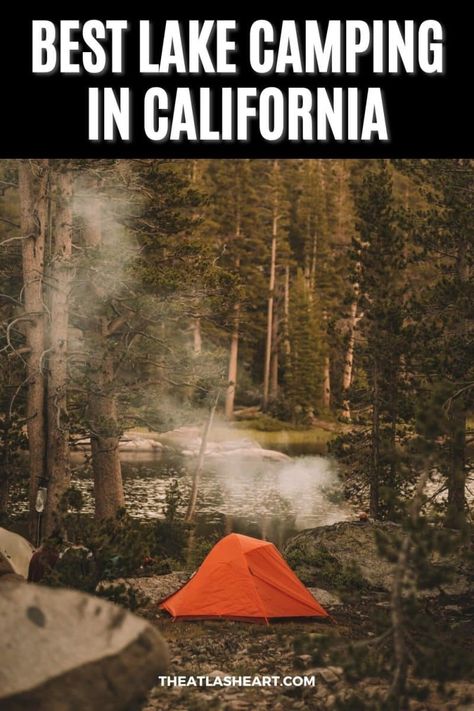 A wooded lakeside campsite with a small orange tent and smoke rising from a campfire, with the text overlay, "Best Lake Camping in California." Fort Bragg California Camping, Convict Lake California, Lake Isabella California, Camping In Southern California, California Lakes, Camp Hacks, June Lake California, Bass Lake California, Camping In California