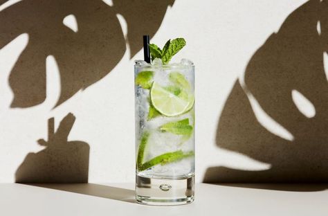 How to Make a Proper Mojito | Wine Enthusiast Tonic Water Benefits, Basil Mojito, Vodka Based Cocktails, Basil Cocktail, Spring Cocktail, Water Benefits, Mojito Recipe, Spring Cocktails, Mint Sprig