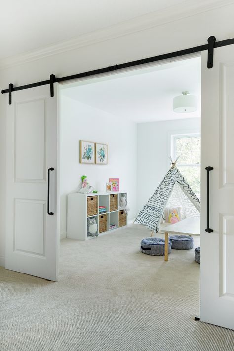 Flex room playroom with barn doors. The landing area opens to a flex room, currently used as a playroom. Bria Hammel Interiors Flex Room Ideas, Modern Kids Playroom, Farmhouse Playroom, Diy Playroom, Barn Style Sliding Doors, Interior Design Minimalist, Basement Playroom, Interior Sliding Barn Doors, Playroom Design