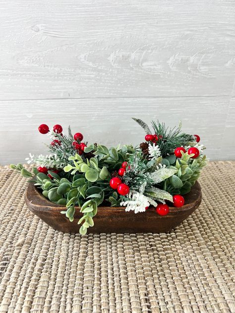 Super pretty wood dough bowls make a beautiful centerpiece for any spot in your home! I especially love to put these on my entry and console tables, but I also have one on my kitchen island! This beautifully handcrafted wood dough bowl measures 9.5 inches long and about 6 inches wide. Measurements of each bowl may vary slightly.  Filler shown in the photo consists of 2 faux eucalyptus greenery garlands,  roughly 8 inches each and 3 holiday floral bundles, consisting of sparkly mistletoe, red ber Rustic Christmas Dough Bowl, Dough Bowl Centerpiece Summer, Black Dough Bowl Decor, Wooden Dough Bowl Centerpiece Christmas, Christmas Dough Bowl, Simple Table Centerpieces For Home, Christmas Dough Bowl Centerpieces, Dough Bowl Christmas Centerpiece, Christmas Bowl Fillers