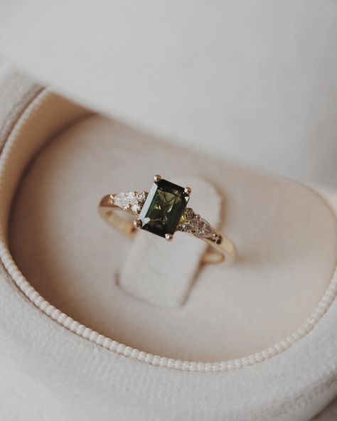 Congratulations Quin + Rae 🥹💍🍾 We customized our Elsie setting, switching out the centre stone for a stunning 6x4mm natural dark green tourmaline with pear and round accents. We wish you the best for your engagement season!! Engagement photos by the lovely: @jordanfayephotography Dark Green Engagement Ring, Olive Branch Jewelry, Gold Ring With Stone, Green Wedding Ring, Green Wedding Rings, Old New Borrowed Blue, Green Engagement Rings, Engagement Season, Beautiful Baubles