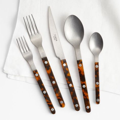 Inspired by well-loved bistro flatware, this 20-piece set brings French cafe style to your table. Stunning tortoiseshell handles sandwich streamlined stainless steel heads that have been given a vintage finish, secured with visible rivets. The result is a modern take on retro flatware—simple and liveable with a touch of edge.     18/10 stainless steel with vintage finish  Acrylic handles  Set includes four 5-piece place settings: dinner fork, salad fork, dinner knife, dinner spoon and teaspoon Copper Silverware, White Dinner Plates, French Cafe, Cafe Style, Salad Fork, Dinner Fork, Old Fashioned Glass, Selling Furniture, Place Setting