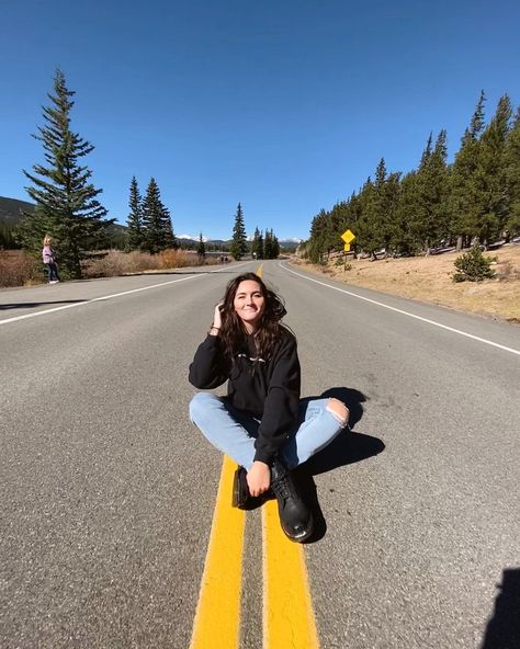 sitting in the middle of a winding road in the mountains Road Poses, Road Pic, Post Caption, Mountain Pose, Winter Road, Sitting Poses, Winding Road, Instagram Pics, Instagram Pose