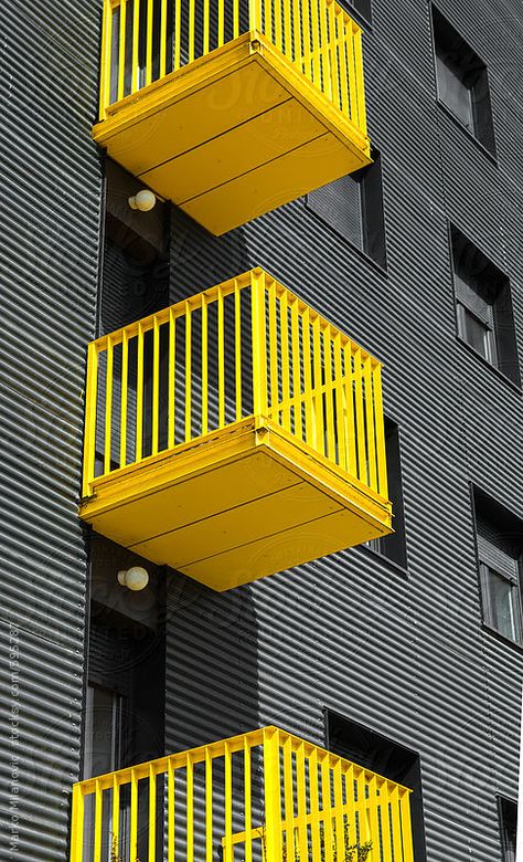 Building detail with yellow balcony on grey/black  facade by Marko | Stocksy United Yellow Balcony, Black Facade, Colour Architecture, Building Facade, Yellow Aesthetic, Facade Architecture, Facade Design, Facade House, Mellow Yellow