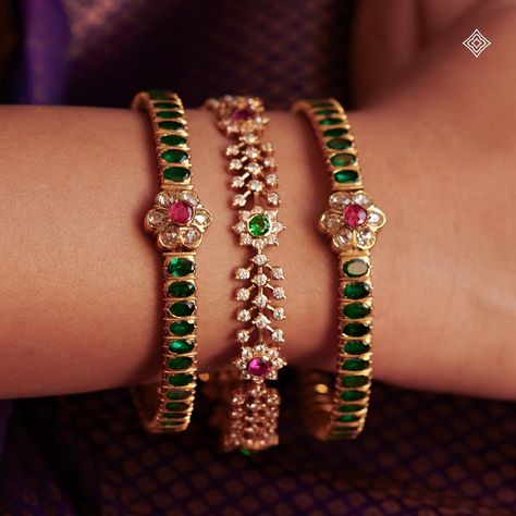 As a bride dons these exquisite bangles, she is not only adorned in beauty but also enveloped in the blessings and legacy of her ancestors, making her journey into married life even more sacred and memorable. Seen here are our 22K emerald kada-style bangles and floral motif stone bangles, each glistening with hints of rubies. WhatsApp 9964641869 for enquiries. 📍Visit the Blue CKC&Co. Flagship store , near Safina Plaza. Look for the DIAMOND logo! Featuring: @@lepana_nagaraj Saree: @aikyath... Stones Bangles In Gold, Black Beads Bangles, Telugu Jewellery, Diamond Bangles Indian, Emerald Bangles, Dressy Jewelry, Stone Bangles, Ruby Bangles, Gold Bangles For Women