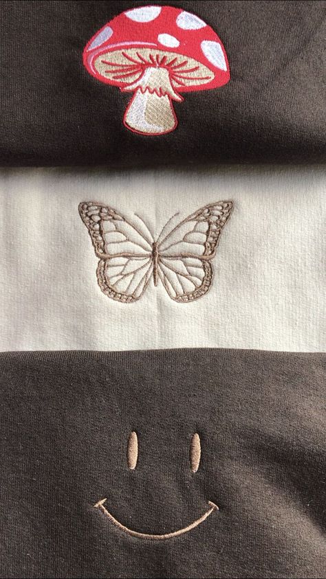 Affordable crewnecks from my small business iblendclothing. More designs on the site! Featured in this pin is our new red and white mushroom, elegant butterfly, and simple smile face desgins stitched out on neutral tone crewnecks in shades beige and chocolate brown. Embroidery Machine Applique Designs, Clothing Fabric Patterns, Mushroom Butterfly, Red And White Mushroom, Off White Hoodie, White Mushroom, Beige Sweatshirt, Clothes Embroidery Diy