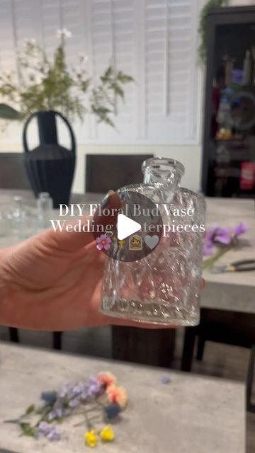 DIY With Jenna 🤍 on Instagram: "Floral bud vase centerpieces DIY ✨🌸🫶🏼  The most GORGEOUS way to include a splash of color without breaking the bank.  Pro tip: check out Facebook marketplace before buying bud vases! I’ve been seeing a ton of brides resell theirs there!  #diywedding #weddingcenterpieces #floralbudvase #budvasecenterpieces #diybride #summerbride #springbride #diyweddingdecor #diyweddingflowers #diywithjenna #weddingflowers #weddingflowerideas" How Many Bud Vases Per Table, Bud Vase Centerpiece Ideas, Ribbon Vase Ideas, Diy Bud Vase Arrangement, Center Piece Wedding Ideas, Different Vases Centerpiece, Boho Wedding Centerpieces Diy Simple, Bud Vase Floral Arrangements, Bud Flower Arrangement