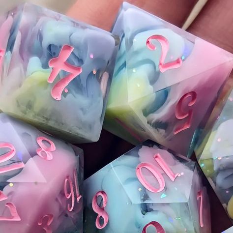 Kess (Sugarmoon Dice) on Instagram: "🌈 Rainbow Candy Fluff 🍭 Available this Saturday! I'll share my site with the listings up as previews to my stories today or tomorrow 🩷🩵 . . . . . #dnd5e #dnd #ttrpg #ttrpgdice #smallbusiness #polyhedraldice #tabletop #ttrpg #resinart #dicemaking #handmade #gamer #dice #pathfinder" Dnd Dice Ideas, D&d Dice Aesthetic, Dice Inspiration, Resin Dice Tutorial, Dice Ideas, Dnd Gift Ideas, Dnd Dice Aesthetic, Dice Making, Resin Dnd Dice