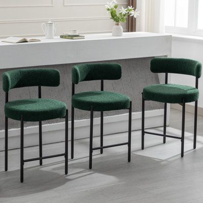 These 24-inch counter height modern, curved-back kitchen island chairs are designed for comfort and style. Featuring a luxurious bouclé fabric, these bar stools with a backrest provide a cozy seating experience. Their sleek, curved back design adds a touch of elegance to your space. Ideal for kitchen counters, these stools prioritize both comfort and aesthetics, making them the perfect addition to home. Ebern Designs Number of Stools: 3, Upholstery: Green | Ebern Designs Najira 24" Counter Stool Kitchen Island Chairs, Green Bar Stools, Counter Stools With Backs, Mid Century Modern Bar, Island Chairs, White Bar Stools, Cozy Seating, Kitchen Counters, Green Home Decor