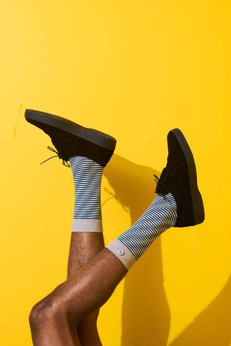 Qnoop fashion editorial for their spring summer SS19 campaign done by their inhouse photographer. Where they focussed themselves on unisex, male and female socks and outfits. Sport outfits were the main styling theme of this collection. Furthermore the yellow background creates a very summer vibe with the shadow, shoes and striped socks. Photography done by Tomek Dersu Aaron and styled by Jet van Beek.  #fashion #editorial #campaign #urban Socks Photoshoot, Socks Photography, Sock Display, Shadow Shoes, Outfits Sport, Shoes Editorial, Shoes Fashion Photography, Editorial Campaign, Campaign Fashion