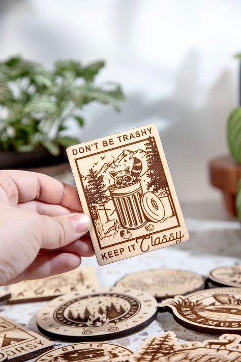 Dont Be Trashy Keep it Classy Engraved Wood Magnet Our Wood Magnets are designed and crafted in-house from quality 1/4 in. engraved plywood. Magnets make great souvenirs from favorite travels, keep track of notes and those pesky to-do lists, or add a little humor to your home or office. +Magnet is about 2.5 in by 3.5 in in size +Quality 1 in. Black Ceramic button Magnet and Attached with a 2-Part Epoxy for strength. +Wood is given a matte finish to seal laser engraving. Please note the color can Laser Engraved Magnets, Laser Cut Magnets, Wood Laser Engraving Ideas, Laser Cut Wood Projects, Laser Cut Wood Ornaments, Wood Engraved Gifts, Laser Cut Wood Jewelry, Leather Burning, Laser Cut Coaster