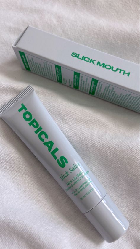 Close up of topical new lip balm next to lip balm packaging, minty lip balm Topical Lip Balm, Topicals Lip Balm, Topicals Lipbalm, Void State, Balm Packaging, Glossy Lip Balm, White Elephant Gift Ideas, Lip Balm Packaging, Mint Lip Balm